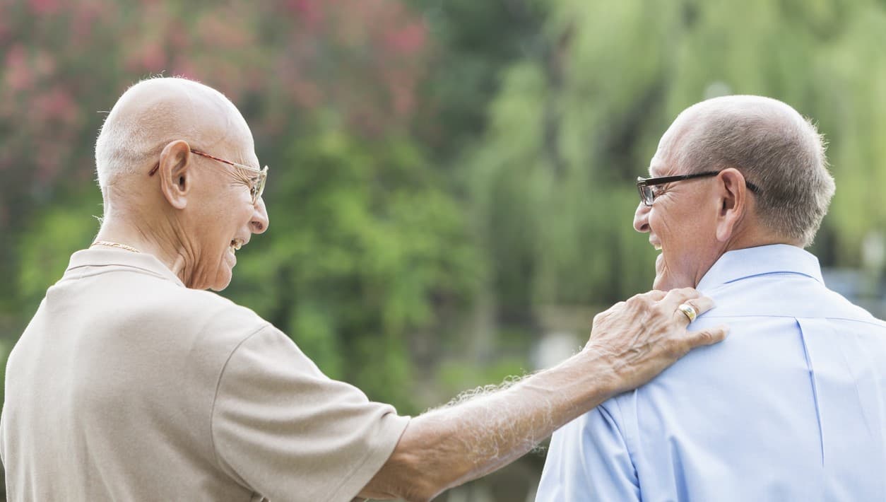 Two men smiling who are sober living after rehab