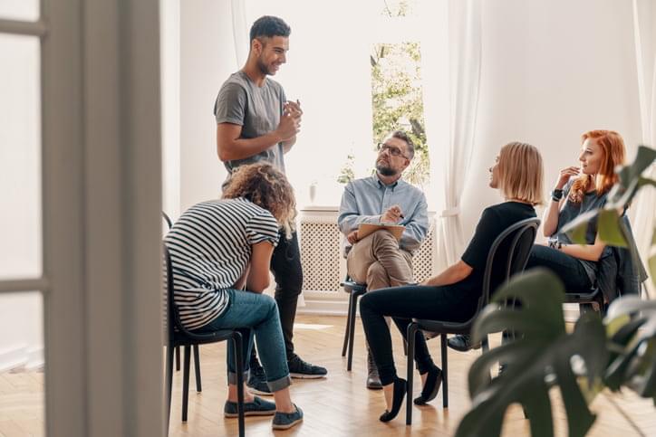 Man in support group about his successful fight with alcohol addiction