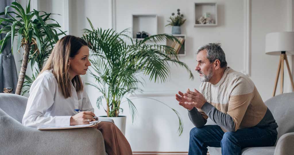 A man in rehab taking a therapy session