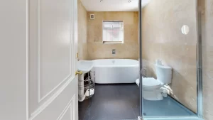 Bathroom with bath, toilet and shower in rehabilitation treatment centre, Ocean Recovery.