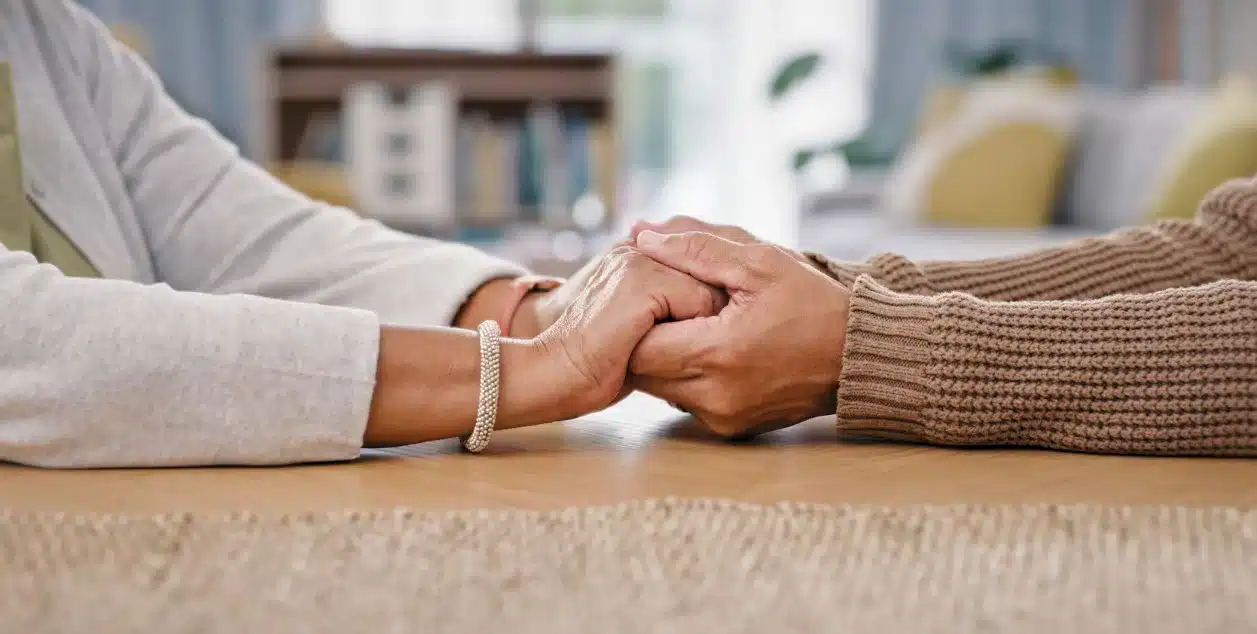 An image of two people holding hands at a table