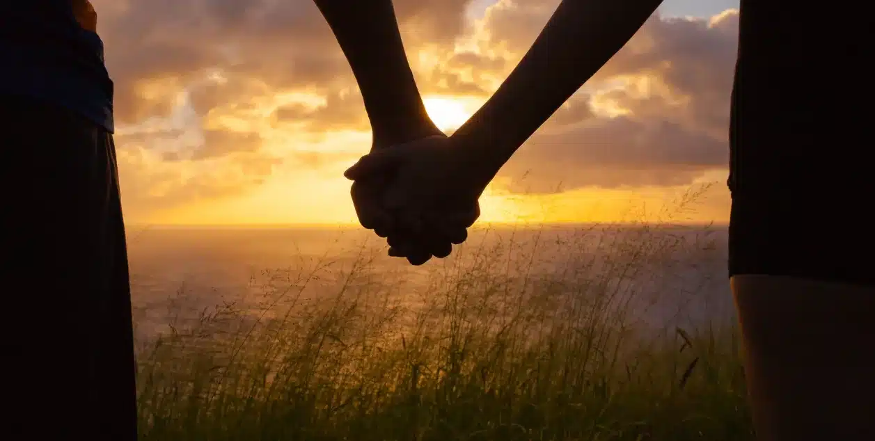 support a loved one through festive period. An image of two people holding hands