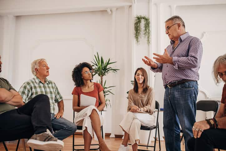 Man talking in group therapy