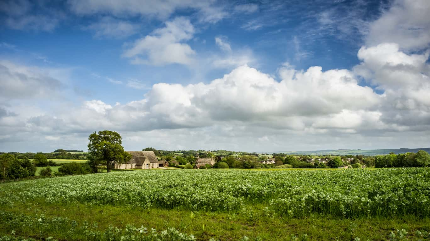 Green fields with a barn in the distance