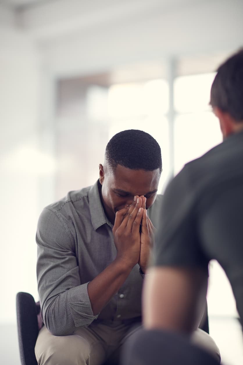 Man in therapy session with face in hands