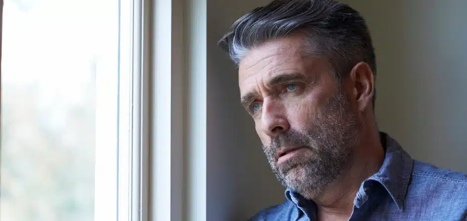 How Do You Know If You Need Rehab? An image of a Mature Man Looking Concerned and Upset Whilst Looking Out Of Window