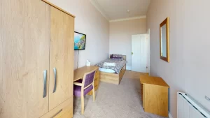 Comfortable, single bed, bedroom for residents staying in a residential rehab treatment centre, Ocean Recovery.