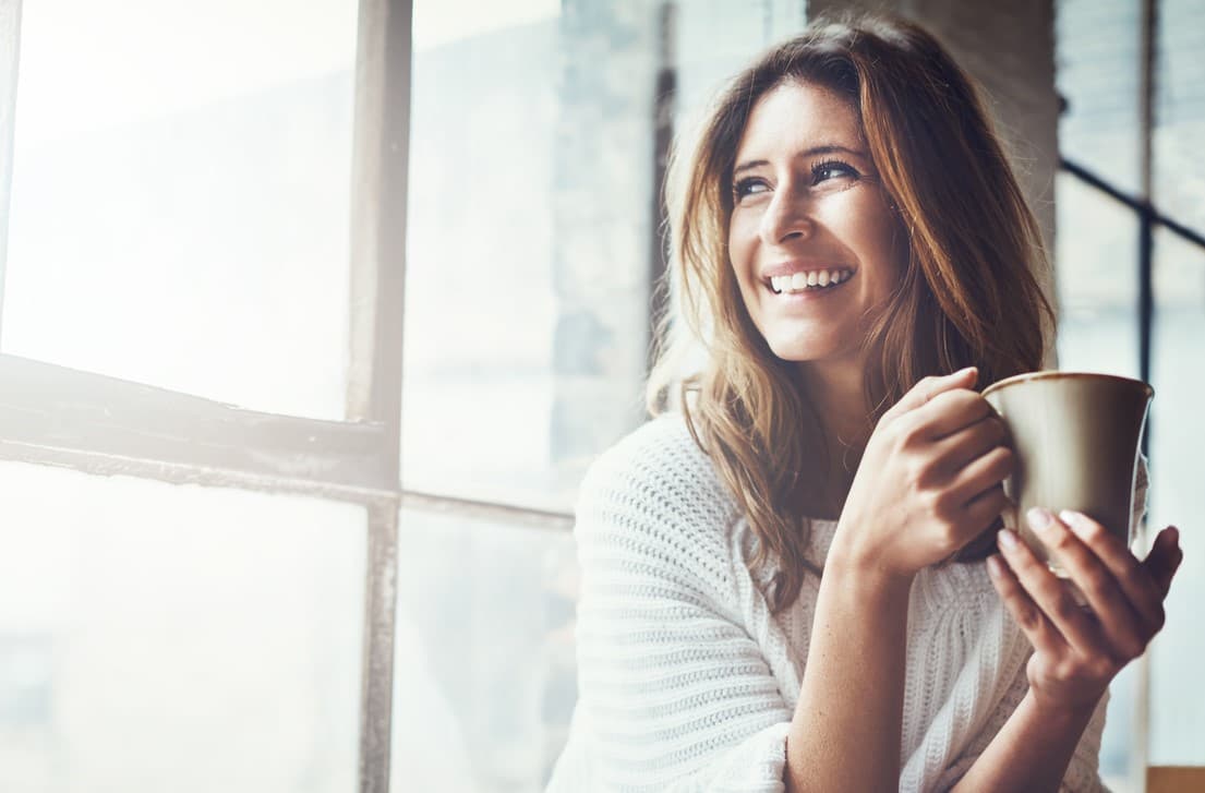 Woman with cup smiling