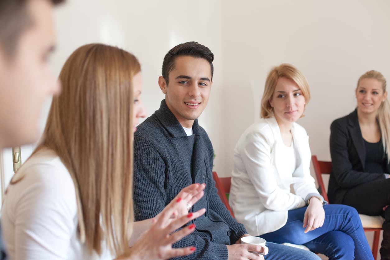 Group of people speaking in rehab