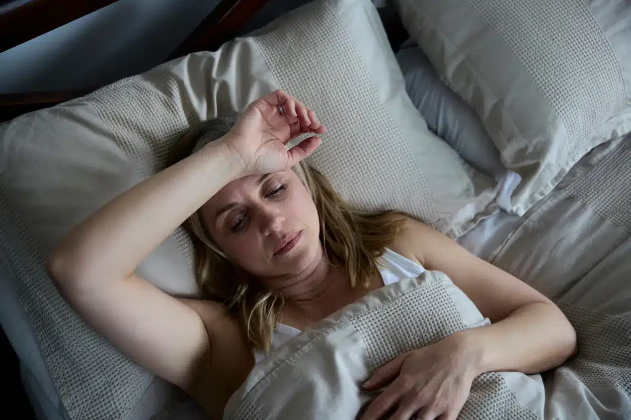 How Long Does Sobriety Fatigue Last For? An image of a blonde woman laying down in bed, appearing tired.