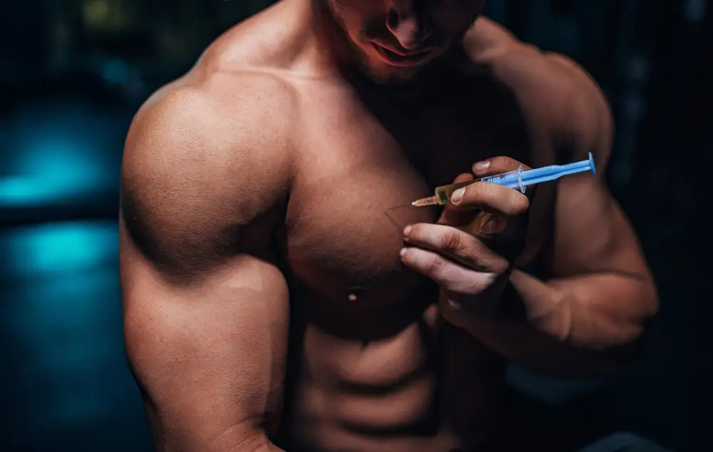 muscular man injecting anabolic steroids