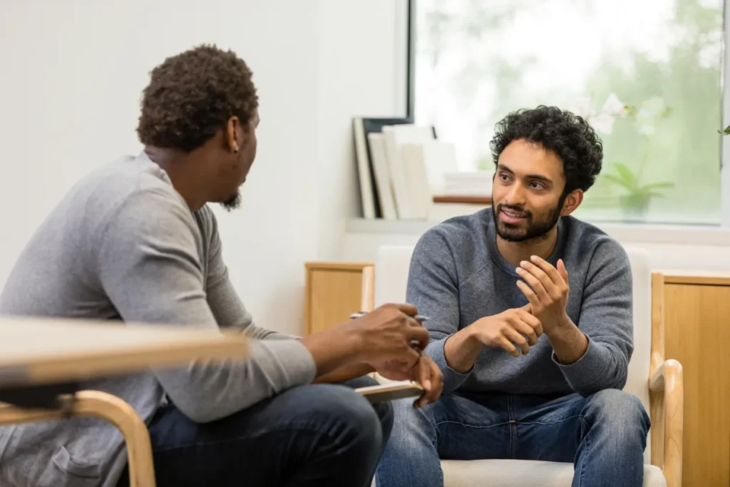man talking to a healthcare professional about addiction