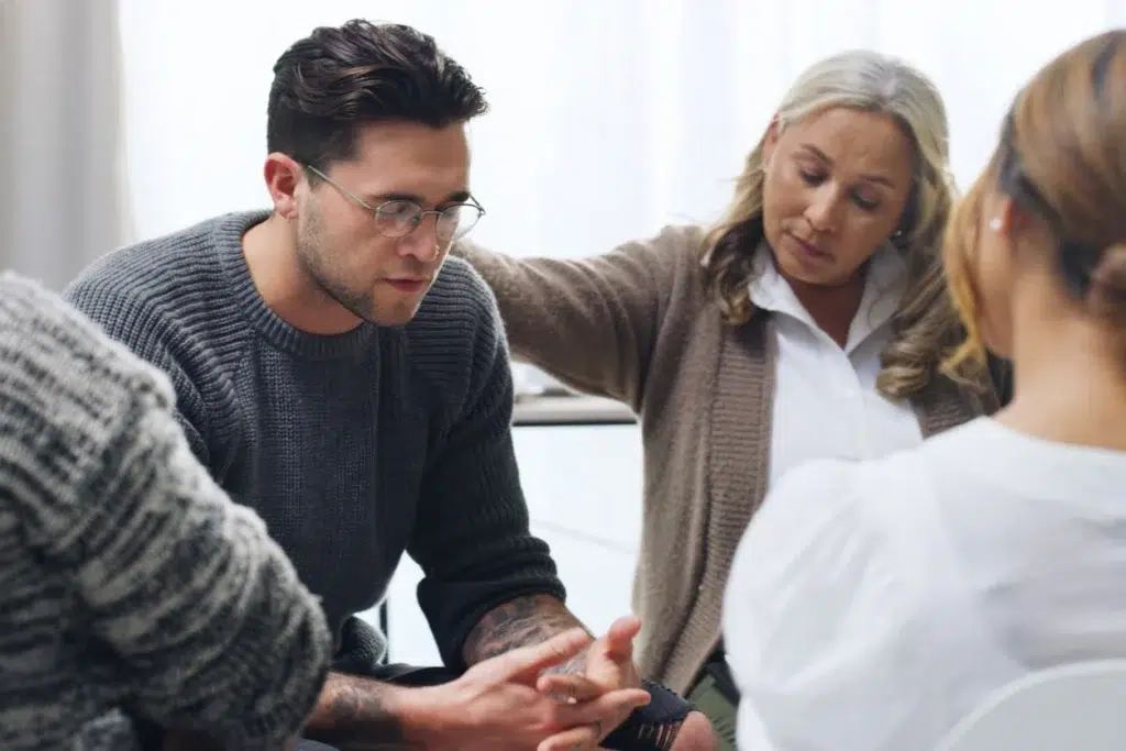 what does Polysubstance mean? A group session in progress with a woman comforting a man